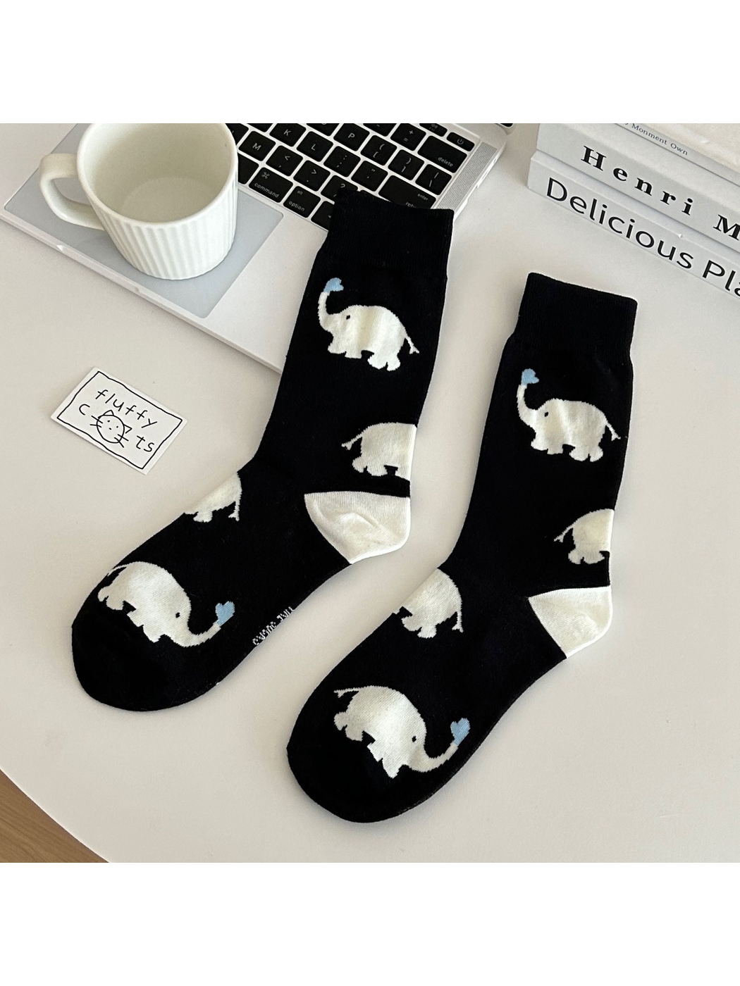 Black crew socks with white elephant motifs and blue heart accents