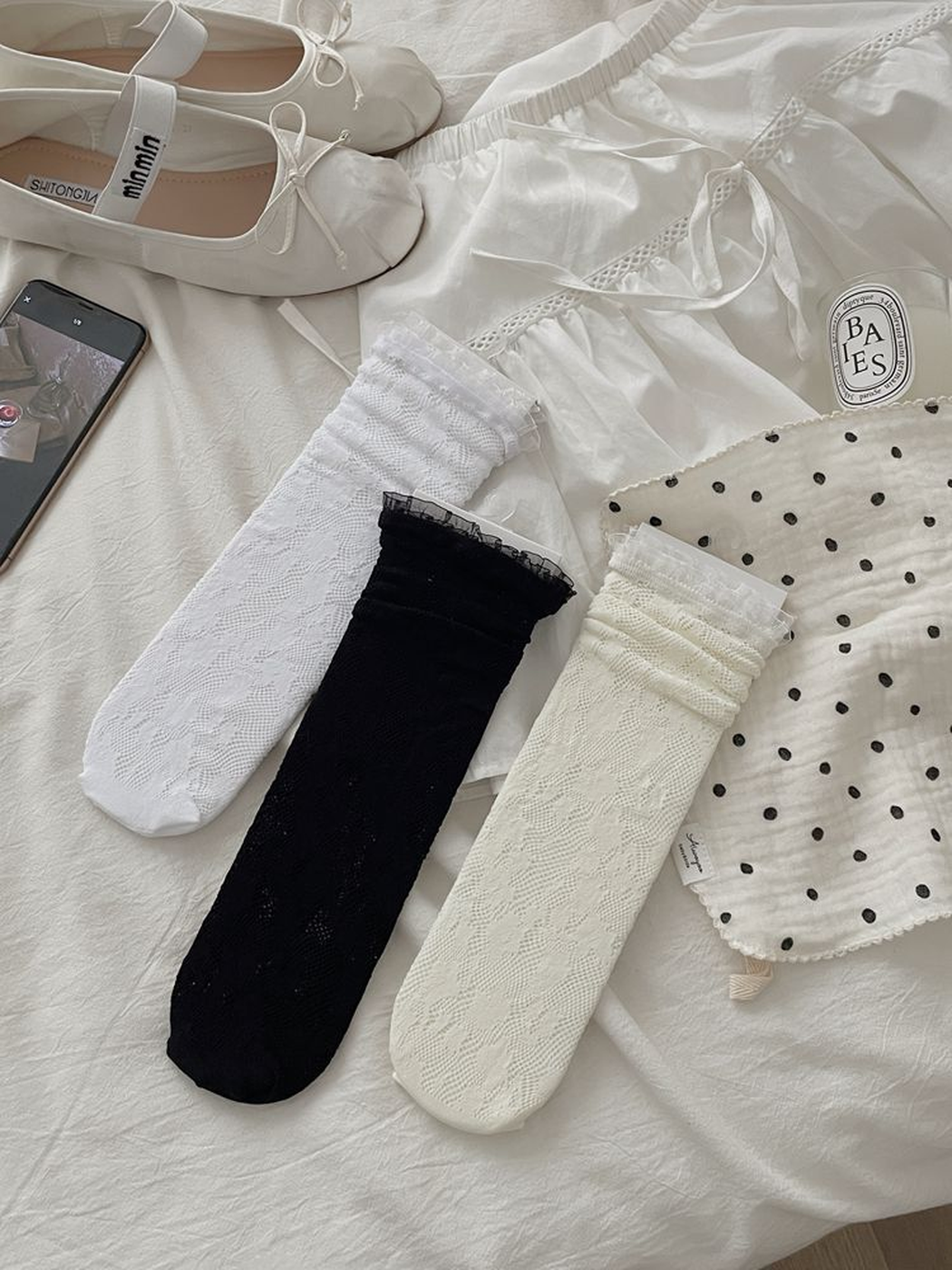 Black, white and ivory floral lace socks displayed together
