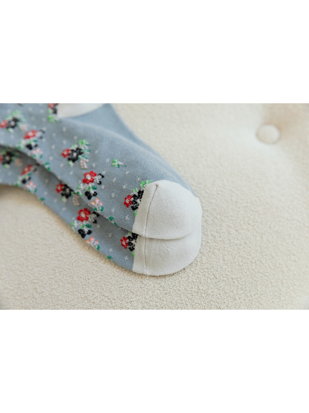 Close-up of the curved seam across contrasting sock toes