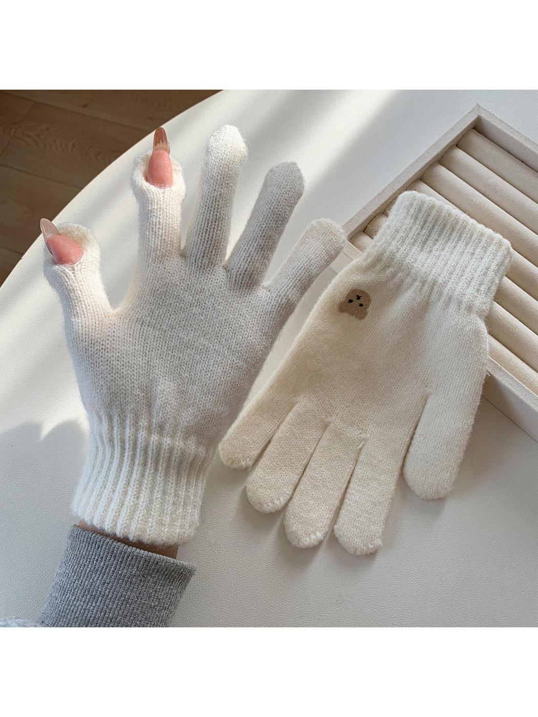 White knit gloves with open thumb and index fingertips