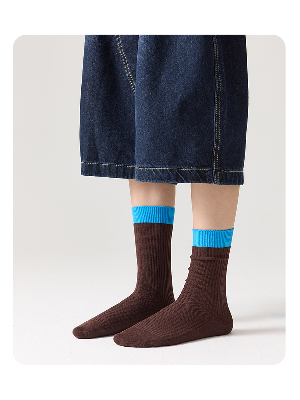 Brown ribbed socks with bright blue cuffs shown without shoes