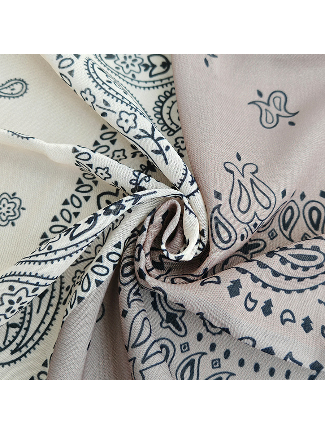 Close-up of the fine woven-look texture and paisley print at gathered folds
