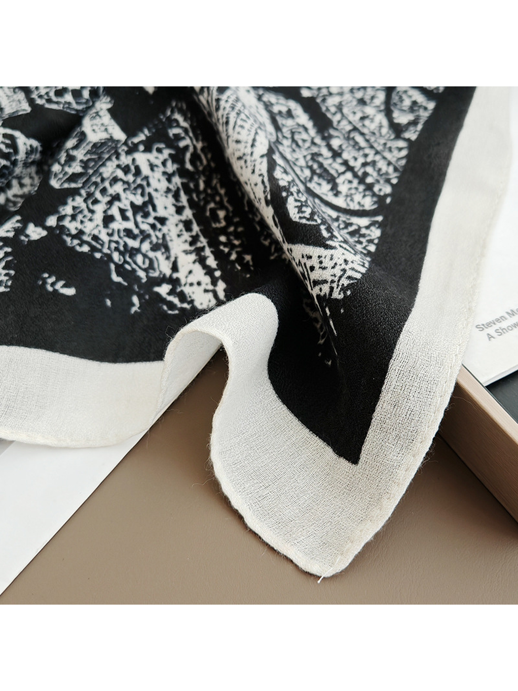 Close-up of the black-base scarf's white border and fine woven-look texture