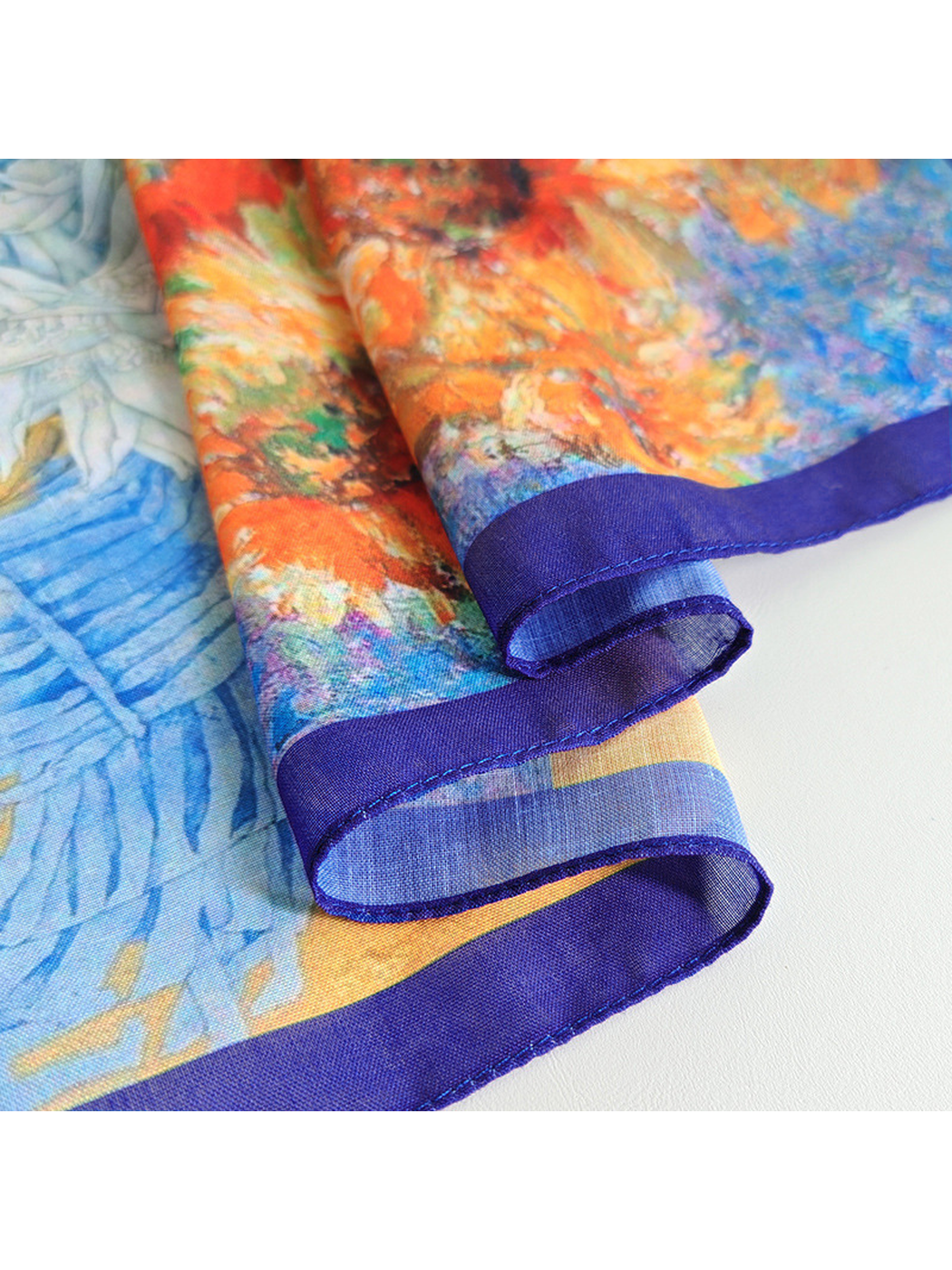 Close-up of the scarf's stitched navy border and printed edge