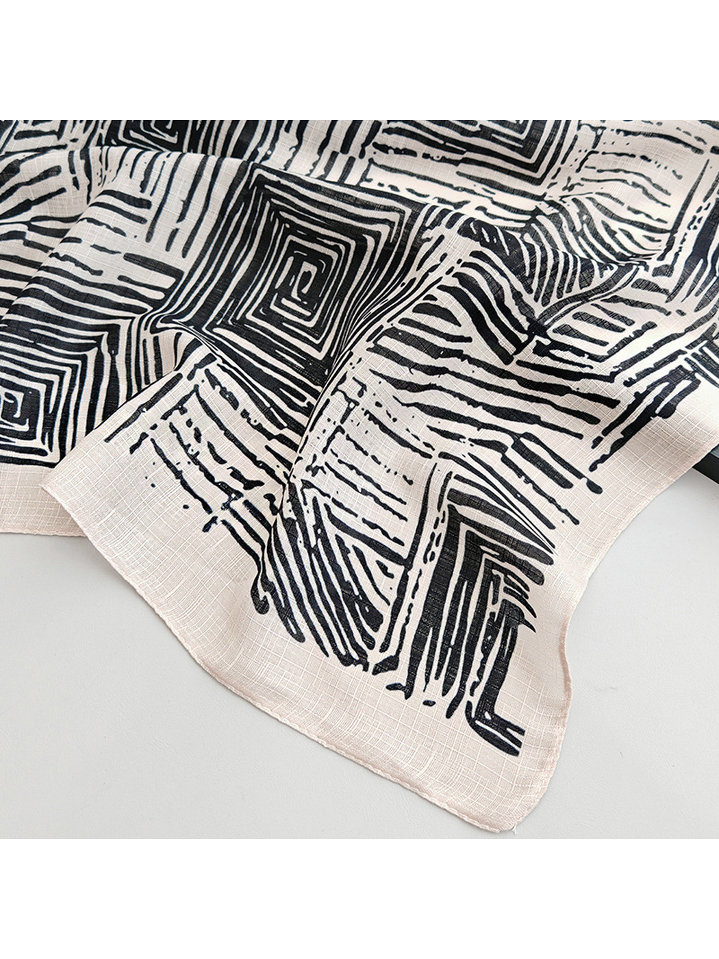 Close-up of the geometric scarf pattern and narrow stitched edge