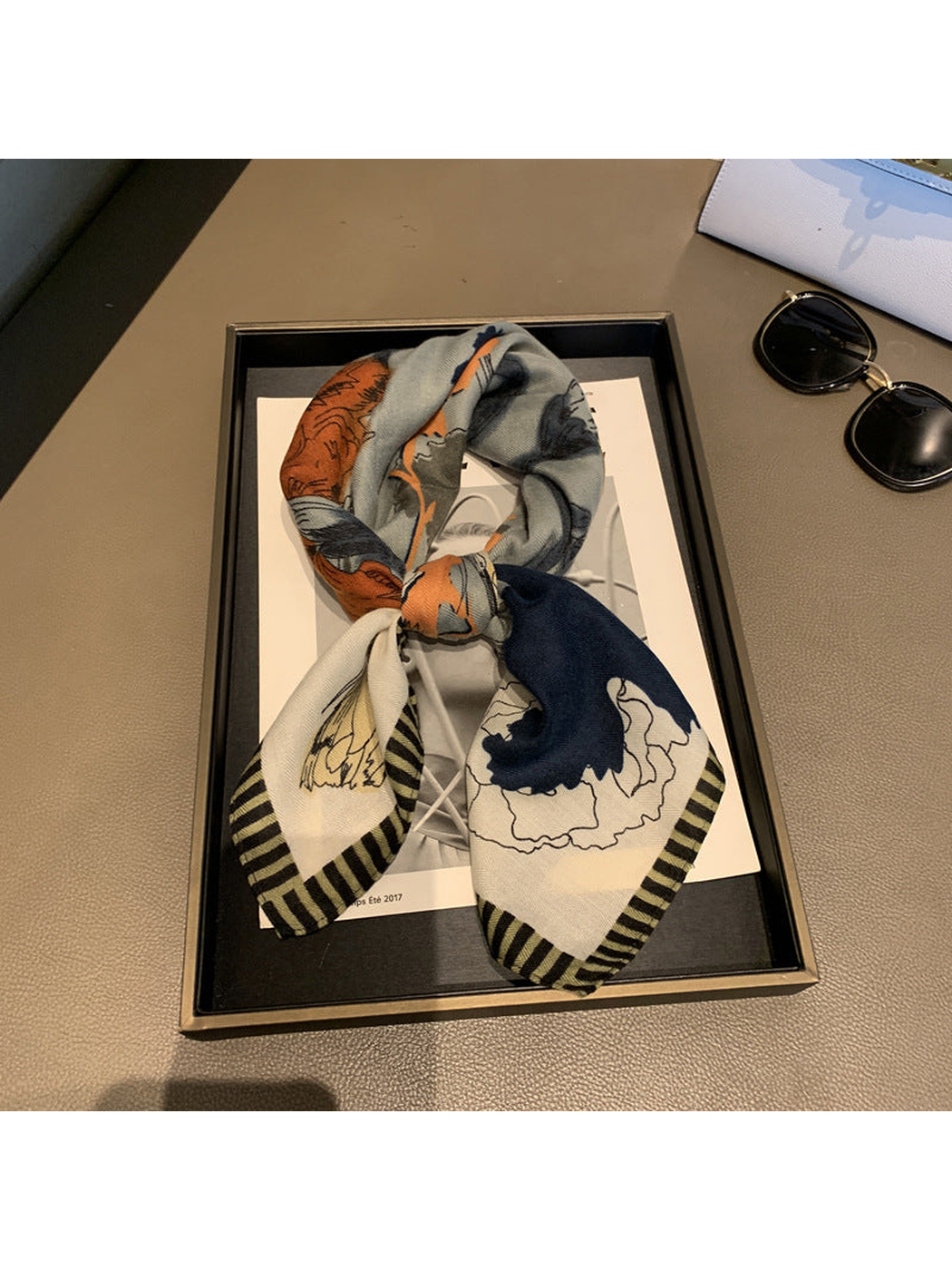 Cream floral scarf tied in a decorative knot