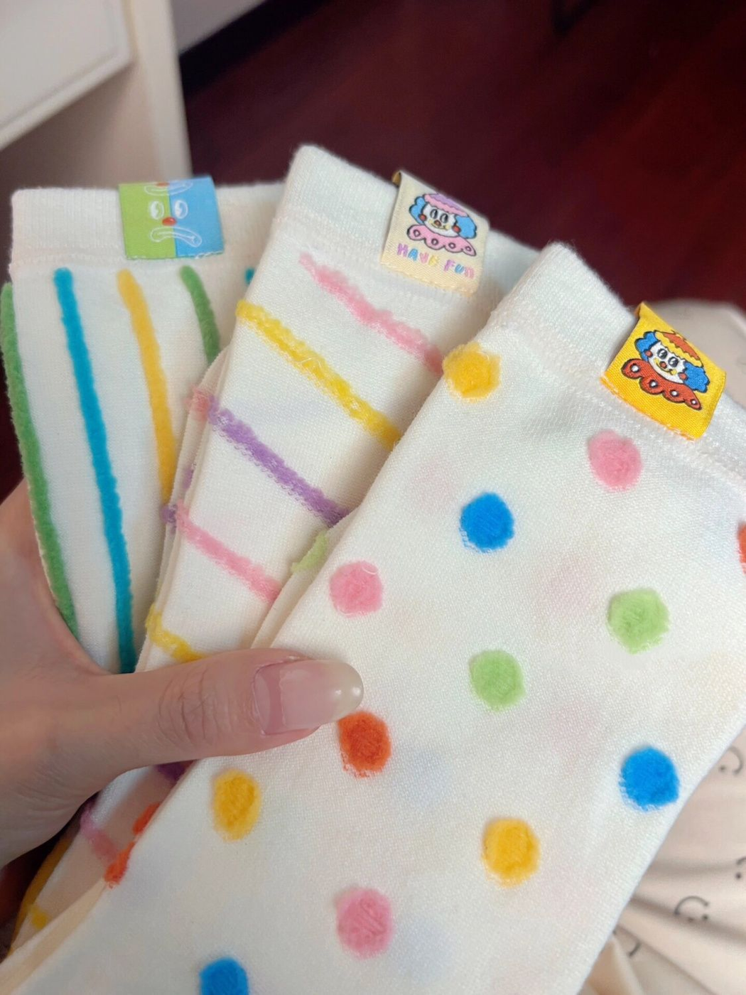 Close-up of ribbed sock cuffs, colorful patterns, and decorative labels