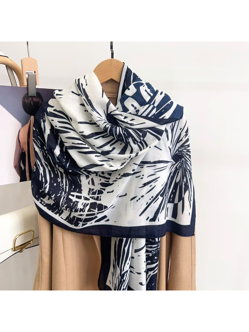Navy abstract-pattern scarf draped over a coat