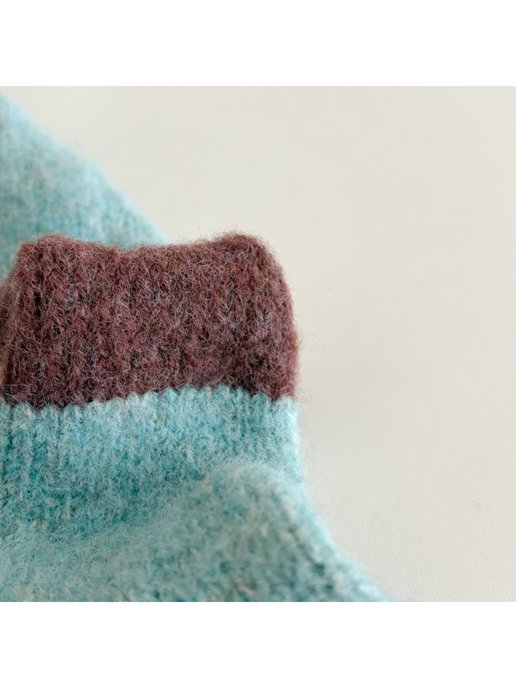 Close-up of the fuzzy texture and ribbed scarf end