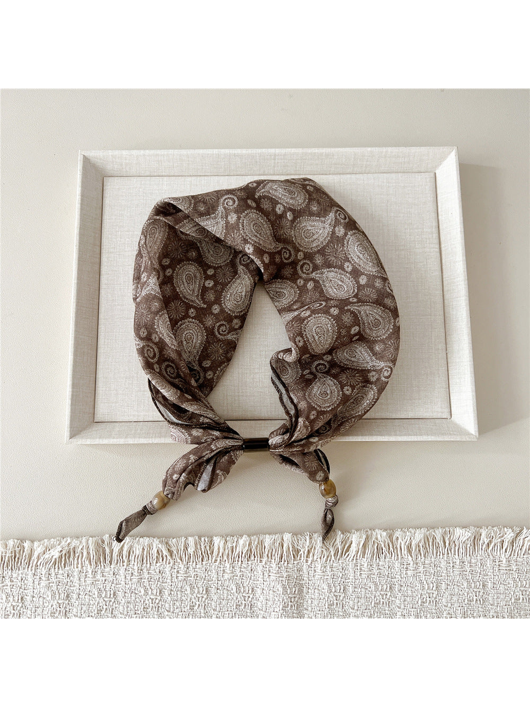Radiating Floral scarf-style headband with cream paisley motifs on brown
