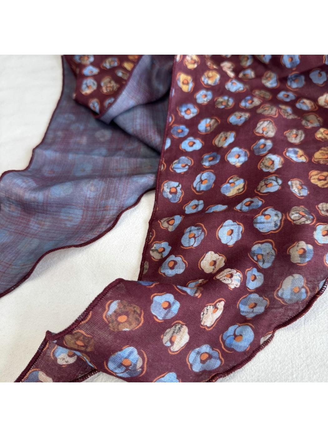 Close-up of the Burgundy Plaid scarf floral print, plaid reverse and stitched edge
