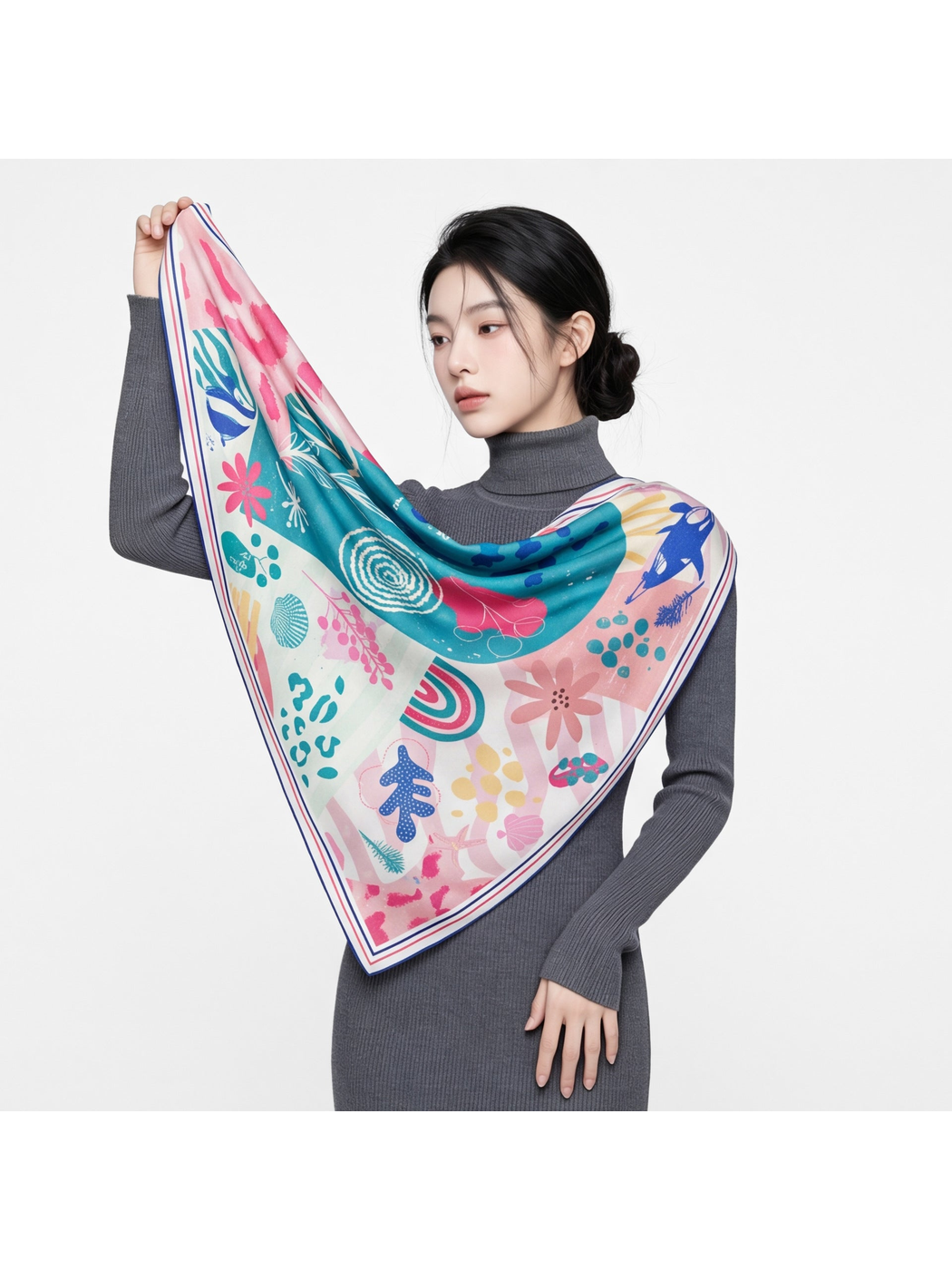 Model holding a multicolor square scarf across the shoulders