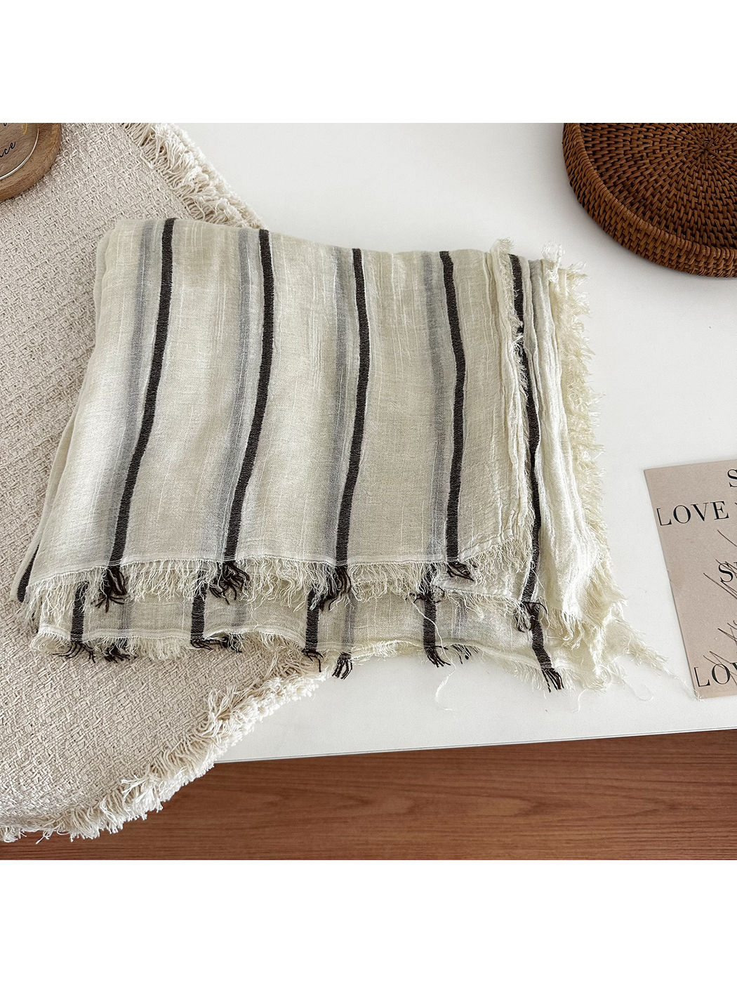 Off White striped scarf folded to show its lightweight drape and fringed edges