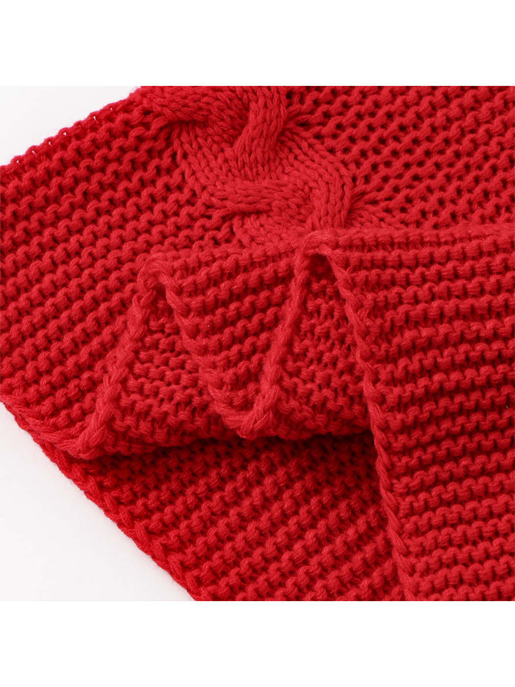 Close-up of the red textured knit and braided cable border