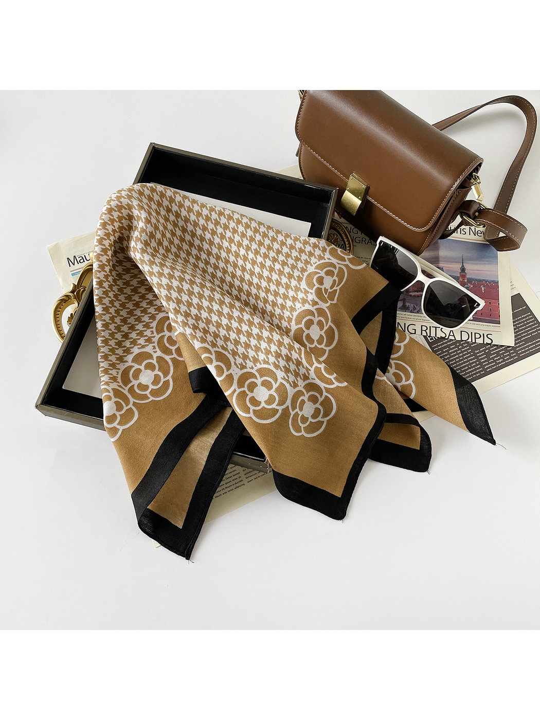 Camel scarf draped in broad folds showing the houndstooth field and floral border.