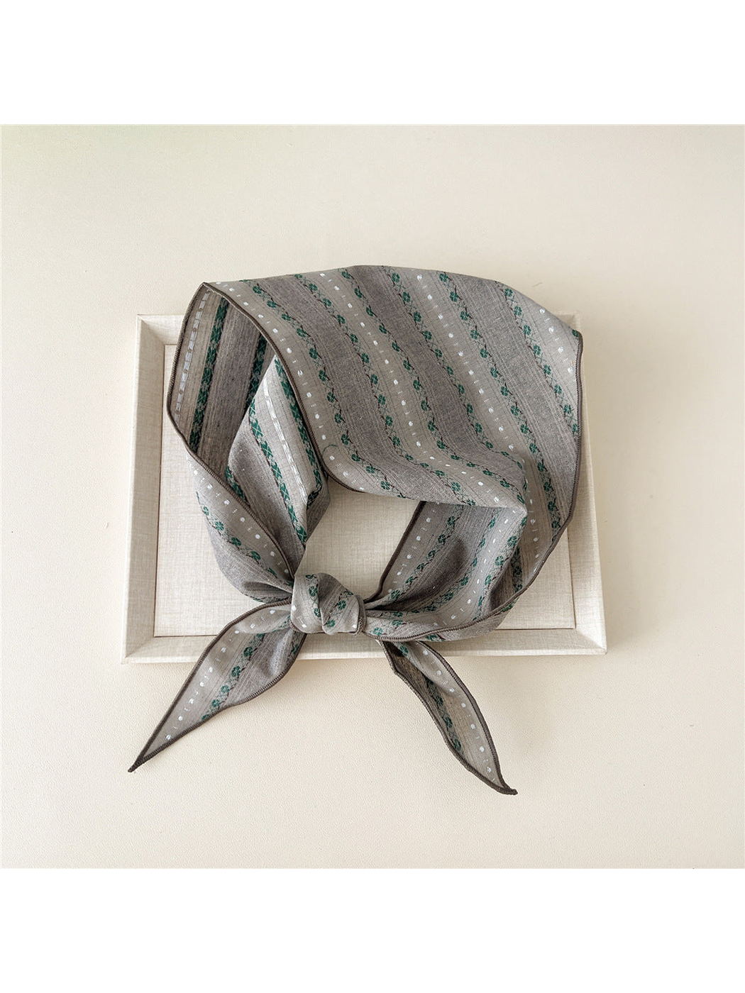 Gray Floral triangle scarf tied over a framed display