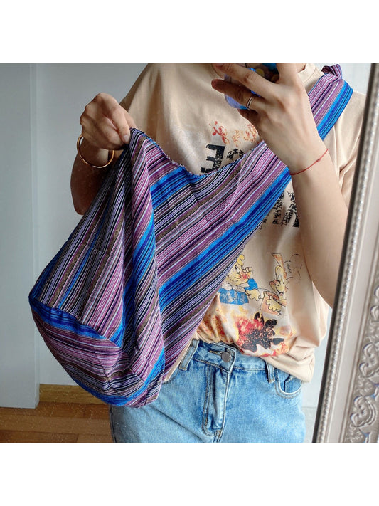 Side angle of Cosbai striped slouchy crossbody bag showing bag shape