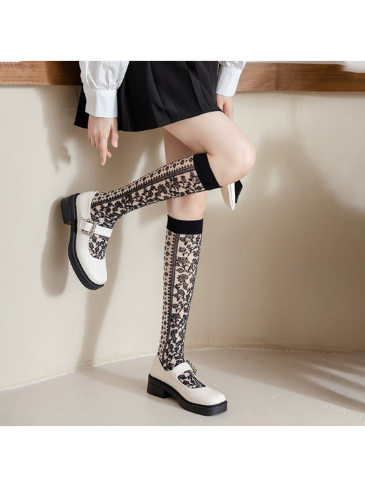 Side view of Rufia knee high sock showing intricate floral lace pattern