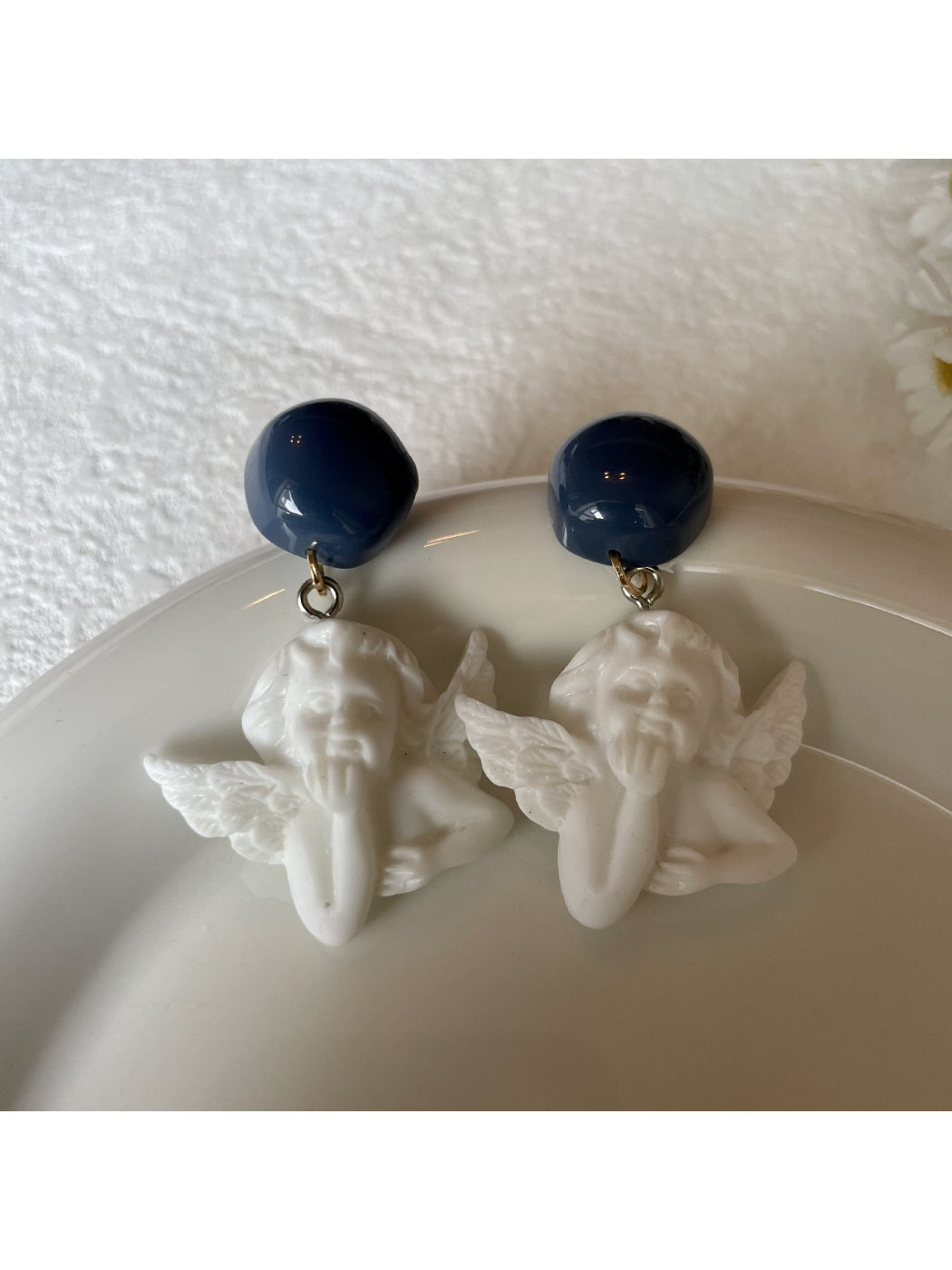 Model wearing Earwish Angel Charm Drop Earrings with silver angel charm