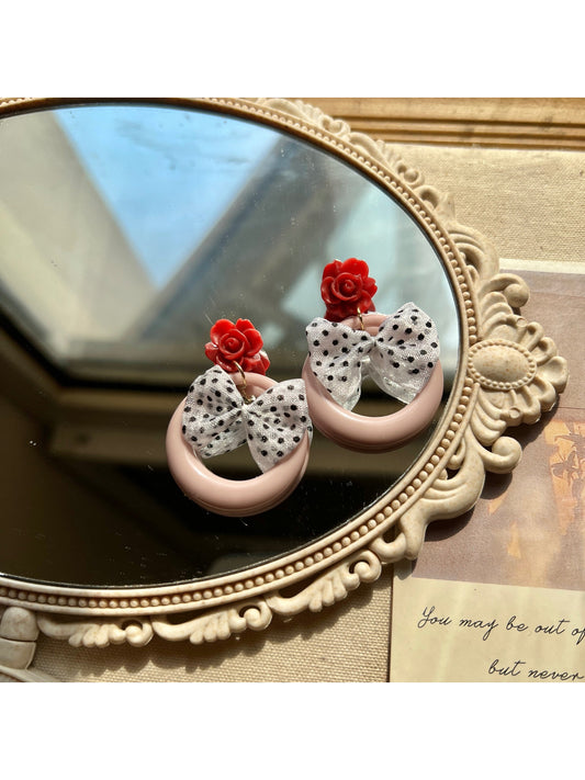 Model wearing Earwish Rose Bow Hoop Earrings showing size and style