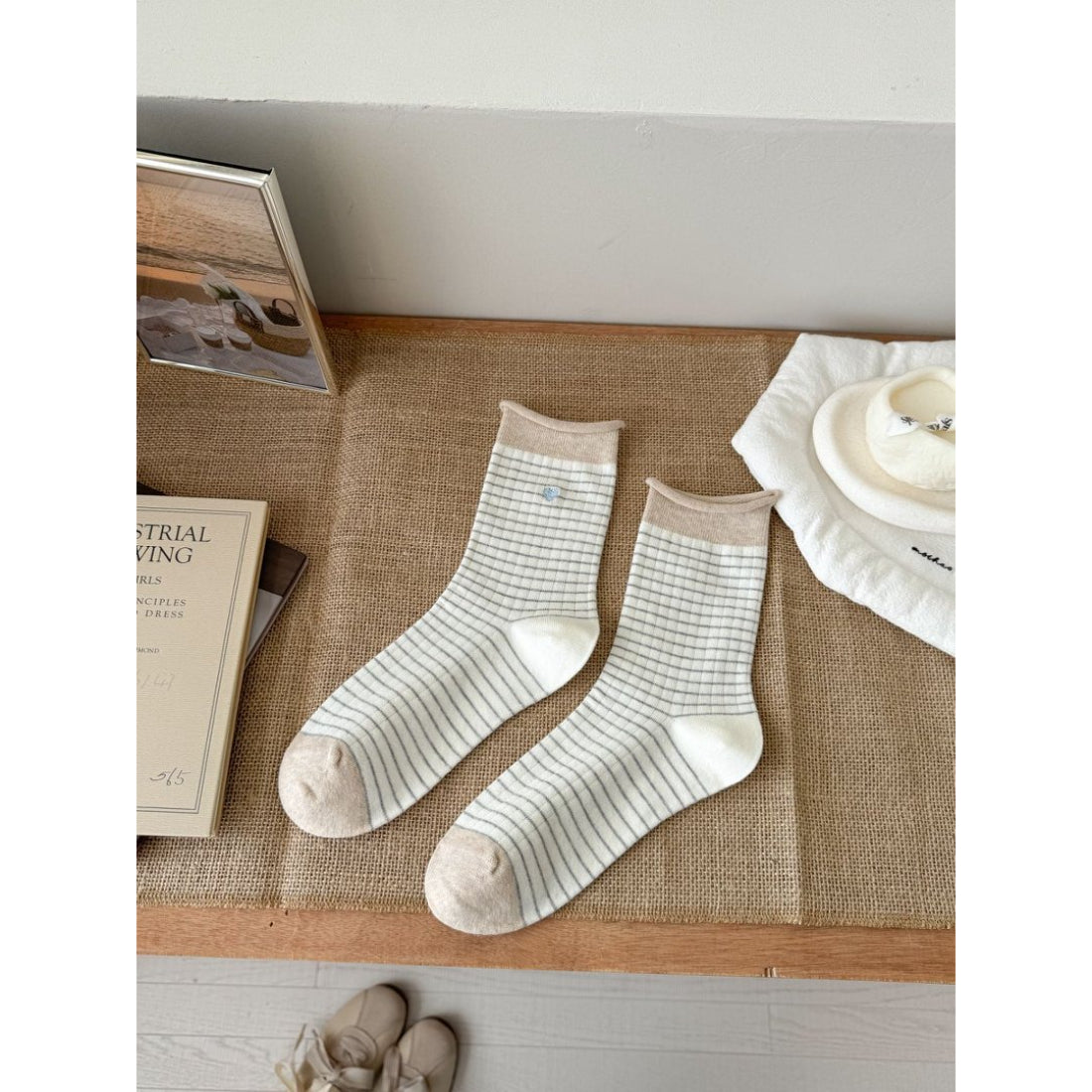Rufia Everyday Stripe Heart Socks paired with sneakers on a wooden floor background