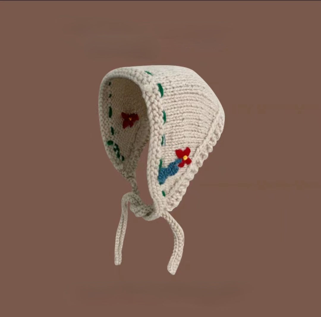 Scarvii crochet cute hairband photographed from above on a plain surface