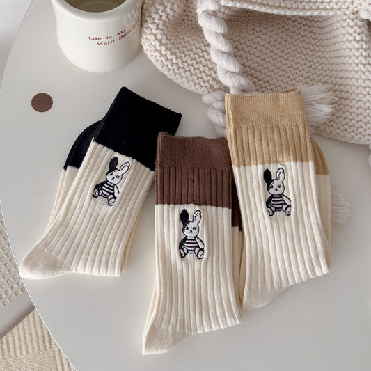 Close-up of Rufia sock with detailed bunny embroidery on soft fabric