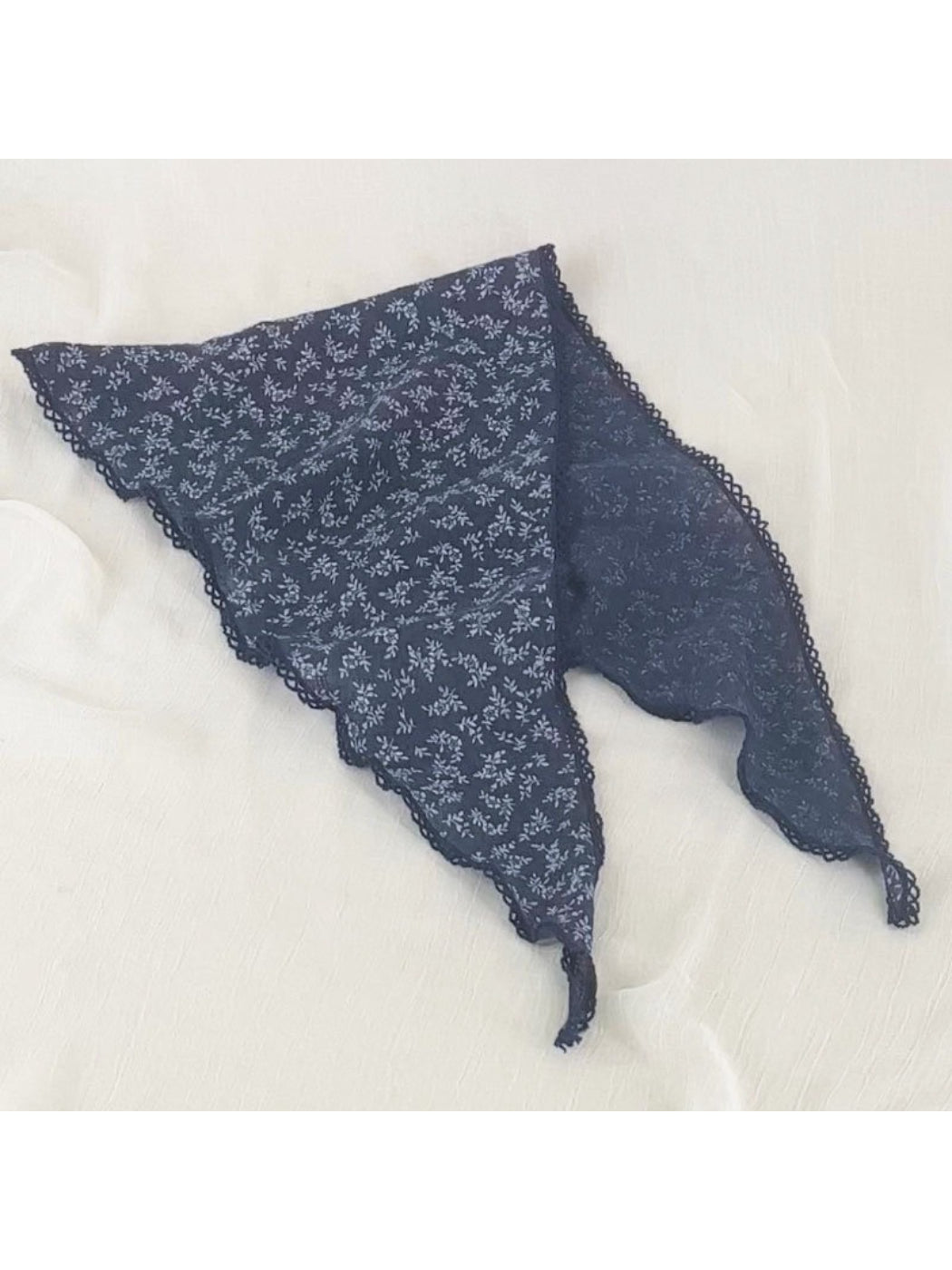 Flat lay of Scarvii bandana headscarf showing full ditsy floral print