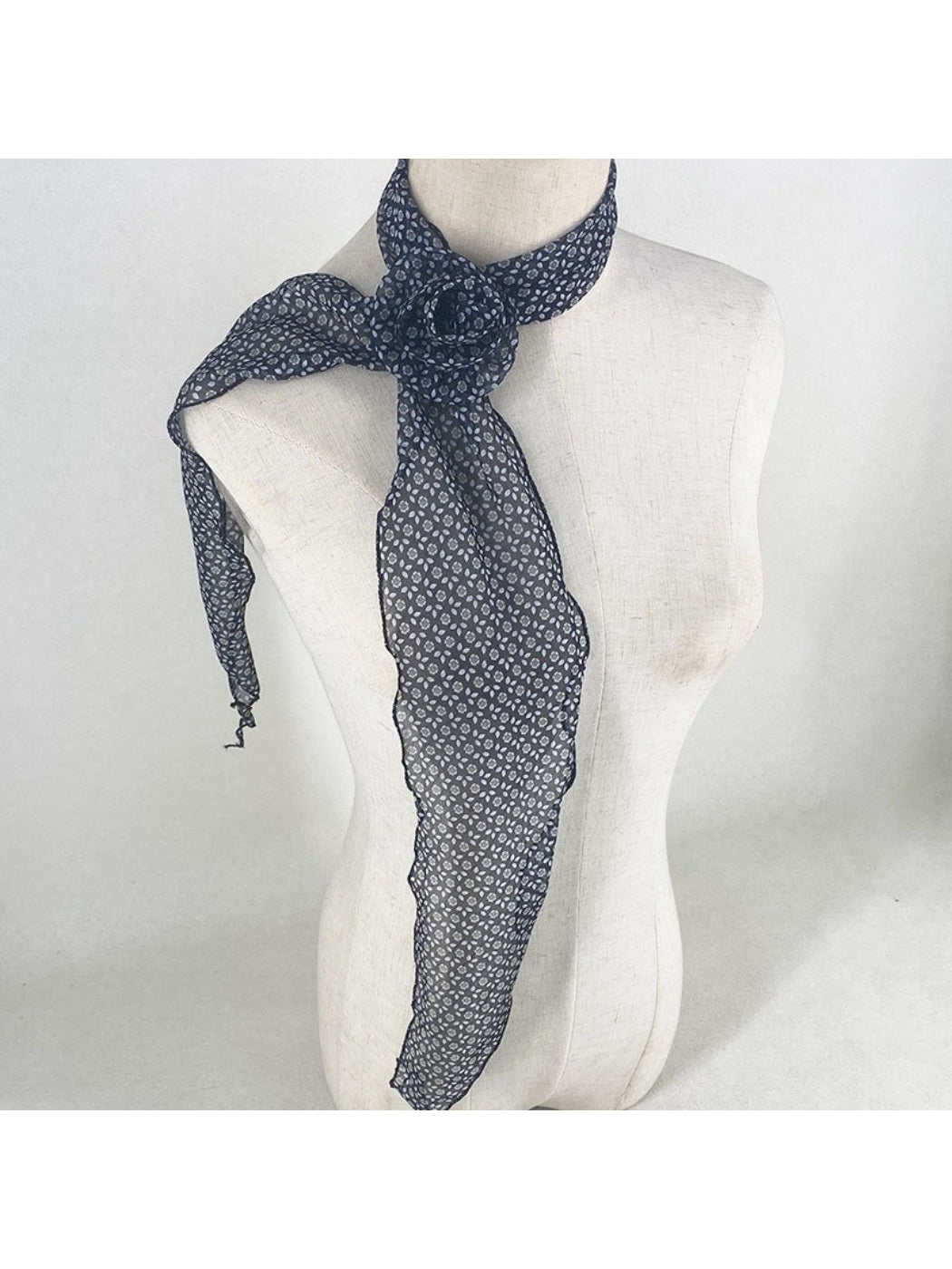 Scarf draped over shoulder highlighting fabric texture and print