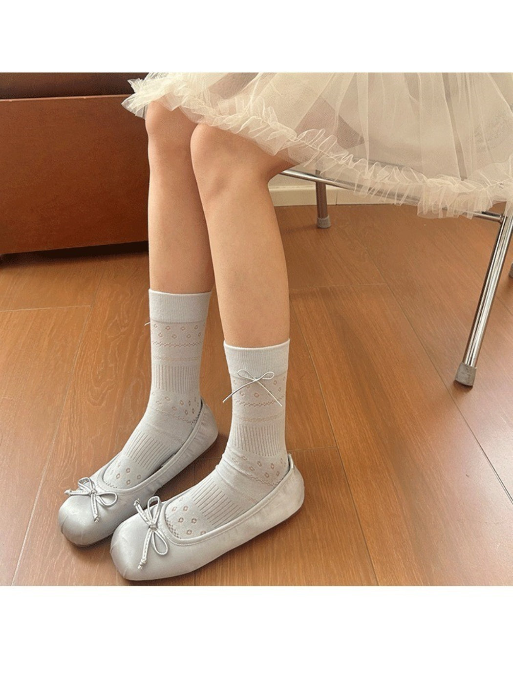 Rufia socks styled with casual outfit on wooden floor background