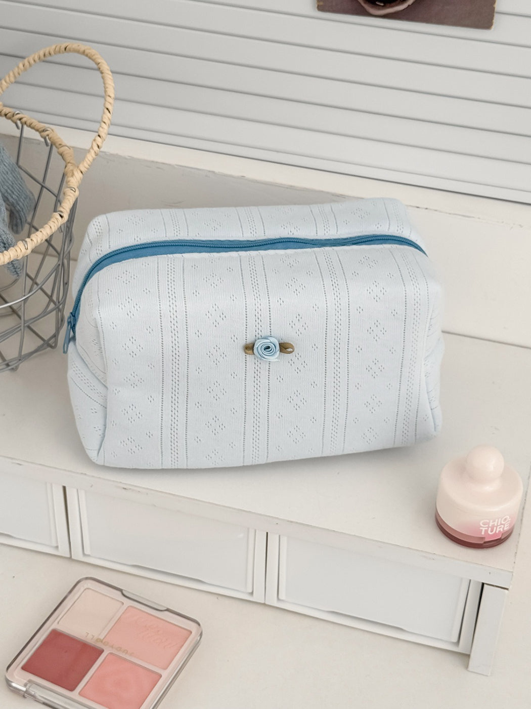 Cosbai cosmetic pouch placed on a white surface with lighting