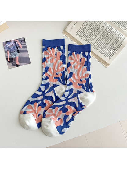 Side view of Rufia modern floral mixed crew socks on model’s feet with visible flower prints