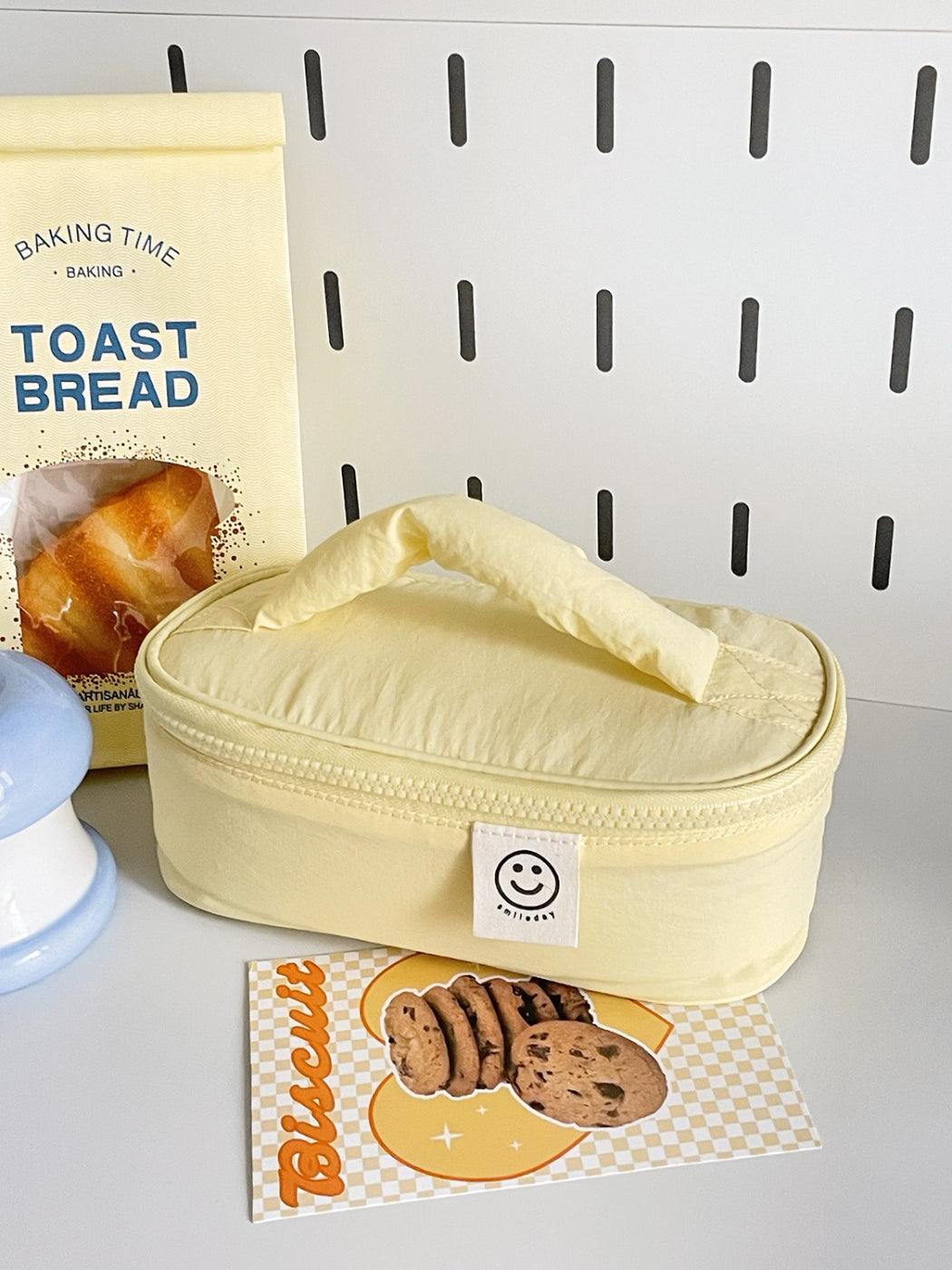 Close-up of Cosbai Smiley Patch Cosmetic Bag with visible smiley patch detail