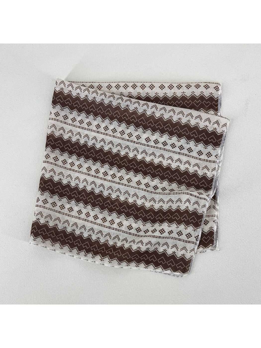 Scarvii square scarf folded into triangle showing detailed geometric print