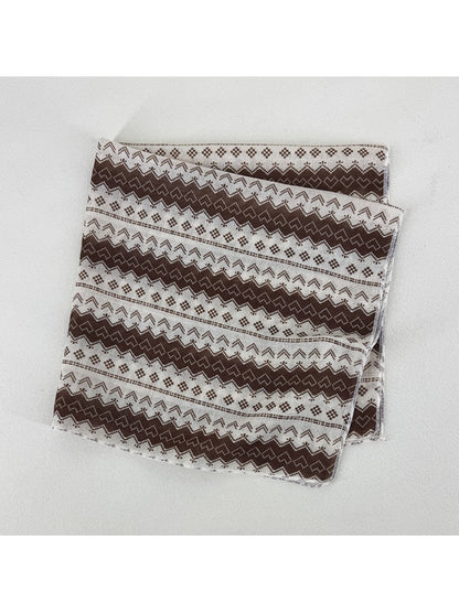 Scarvii square scarf folded into triangle showing detailed geometric print
