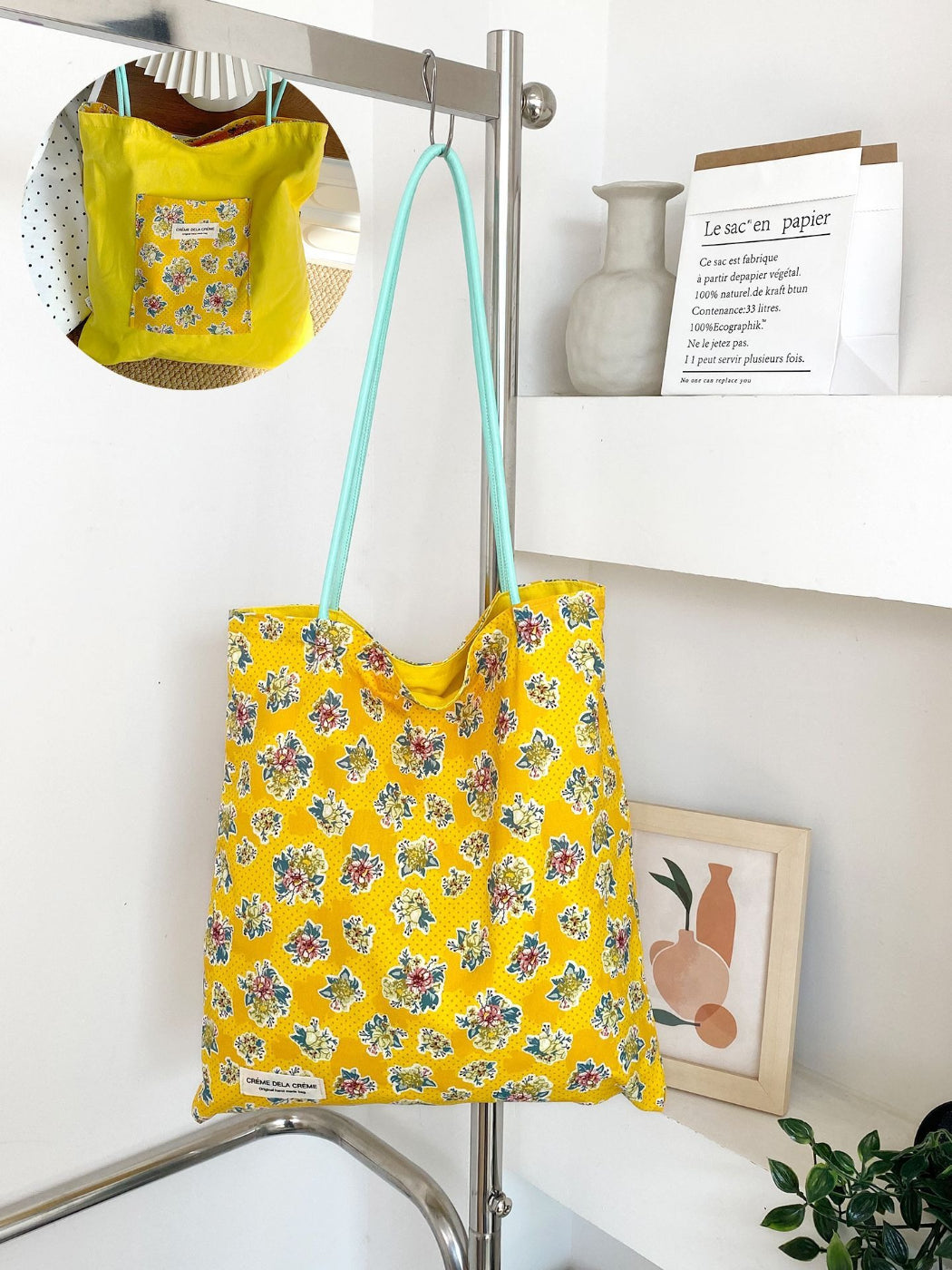 Cosbai tote bag with multicolored floral patchwork design held by a model