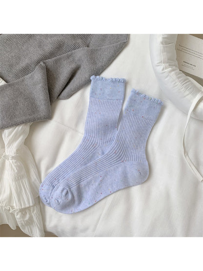 Rufia rib crew socks displayed on wooden surface highlighting speckled knit