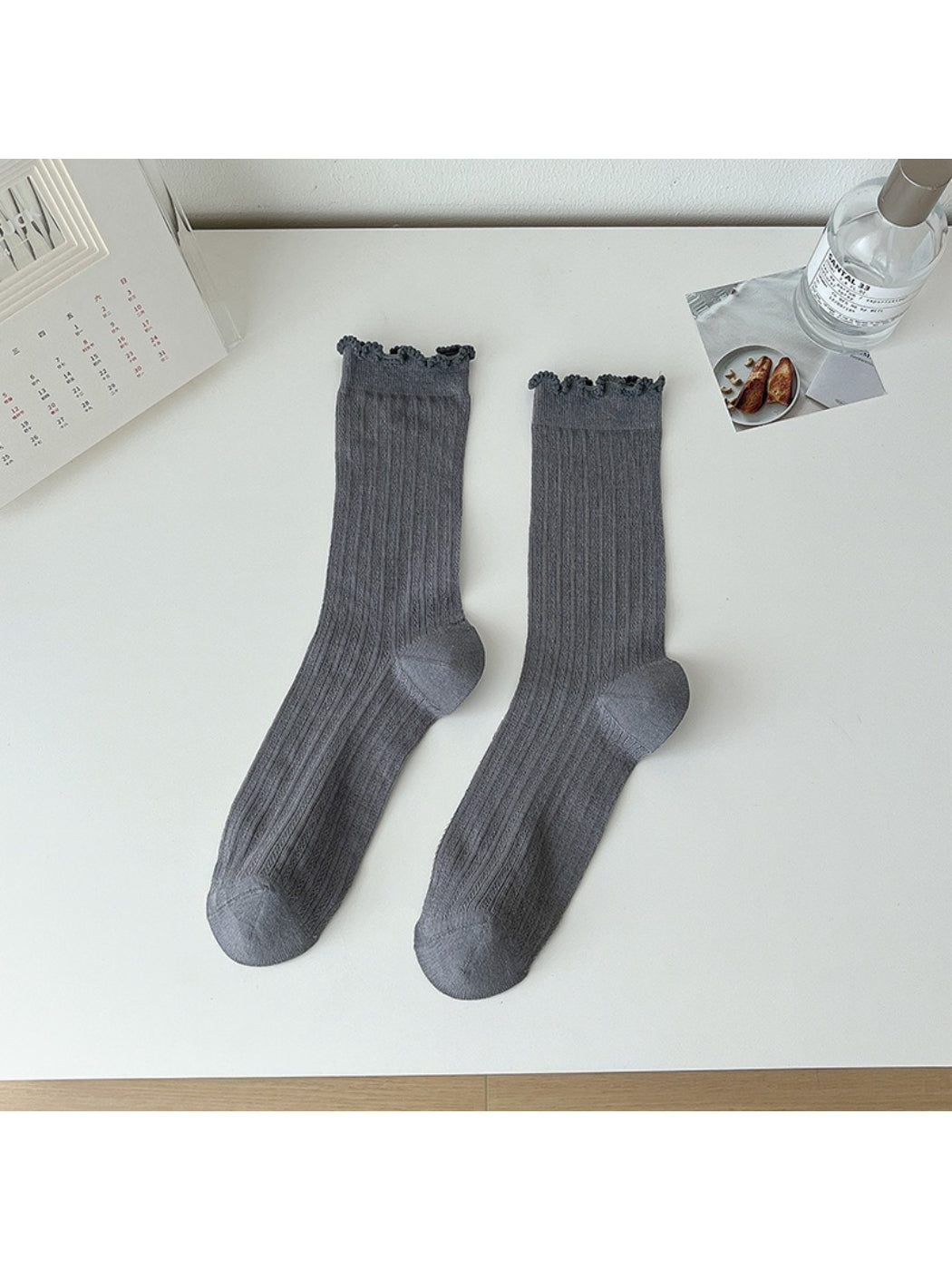 Rufia lace white mid-calf socks paired with a light outfit in natural light