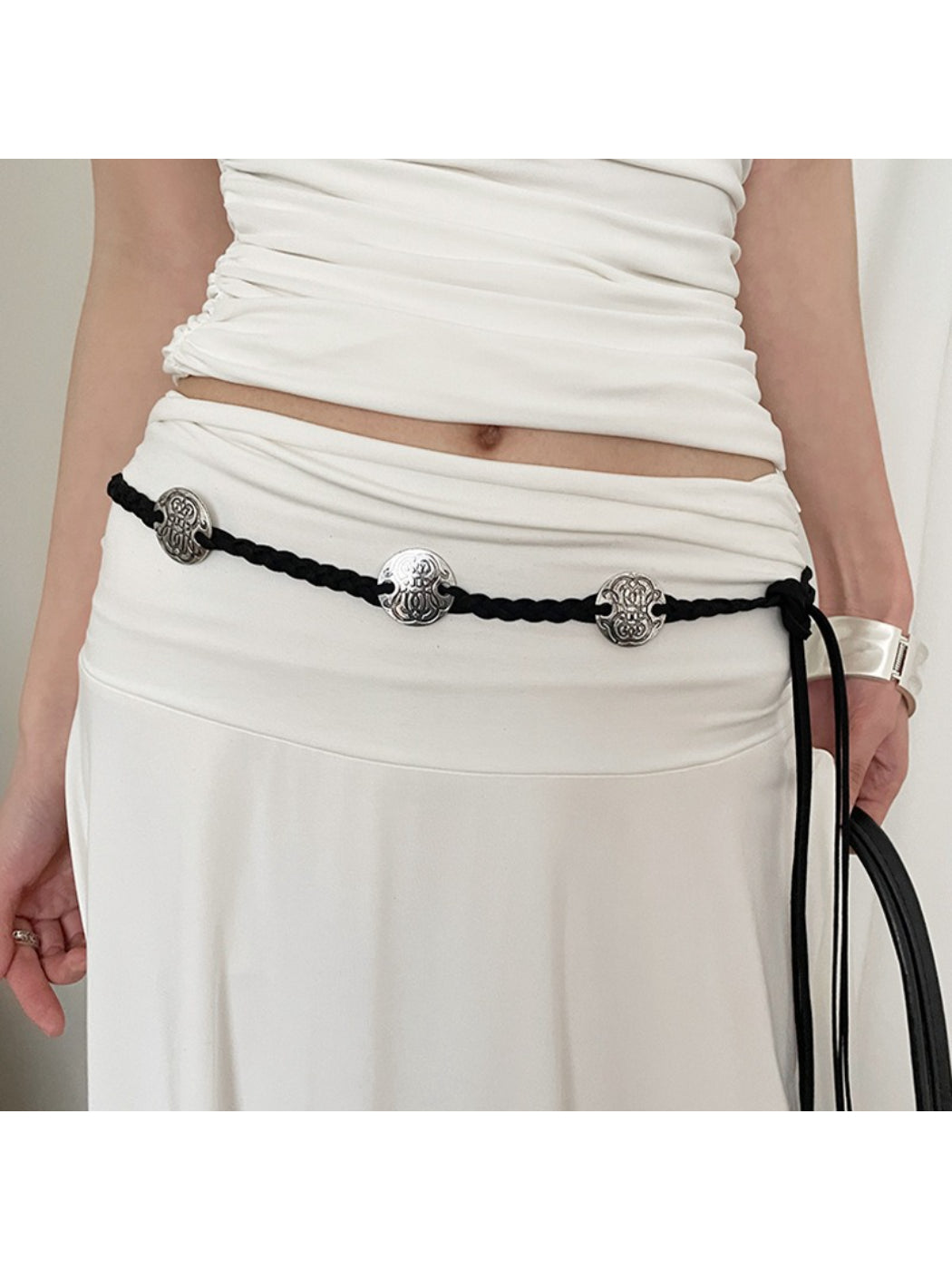Beco vintage style braided rope belt coiled on white background