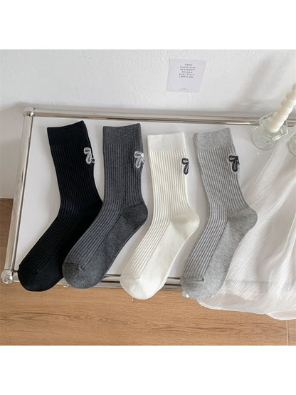 Model wearing Rufia ribbed socks with bow stitch detail and casual shoes