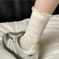Rufia Pale Bow Everyday Socks displayed with one sock slightly folded
