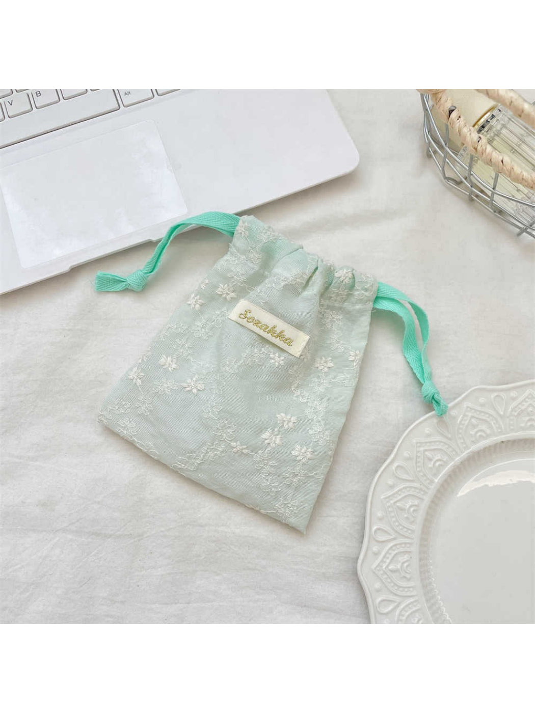 Cosbai floral lace drawstring pouch shown from side angle emphasizing lace details