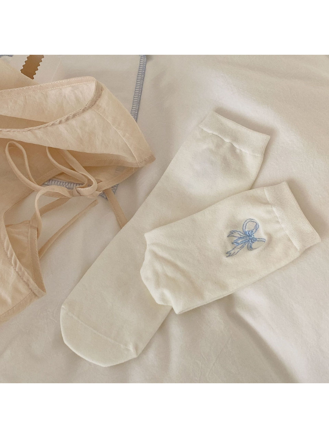 Rufia crew socks in pastel pink folded to show ruffle detail