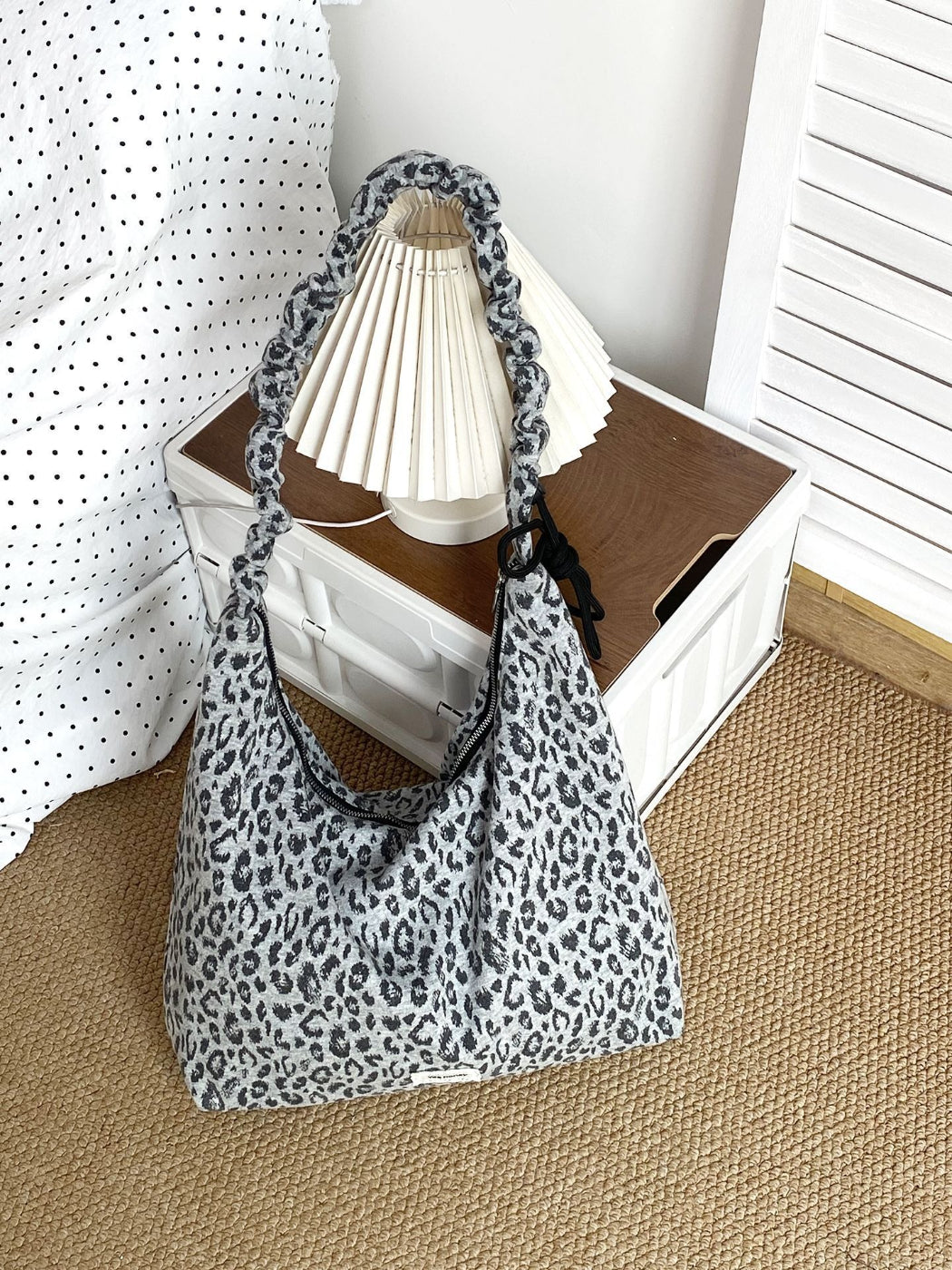 Side view of Cosbai leopard print shoulder bag highlighting slouchy shape and strap detail