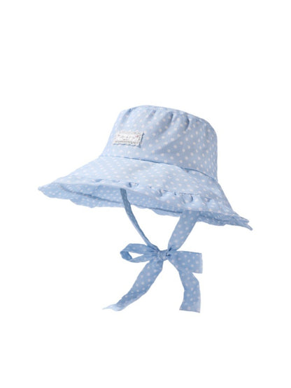 Model wearing Haila ruffle brim polka dot hat outdoors