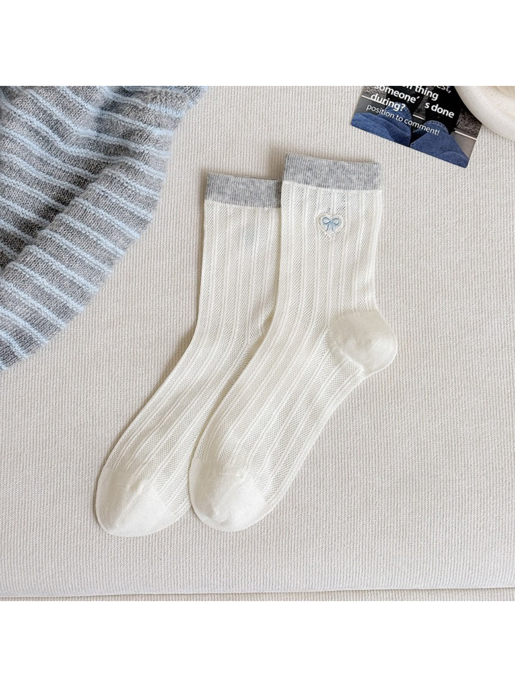 Pastel socks worn on feet, highlighting heart details and soft texture