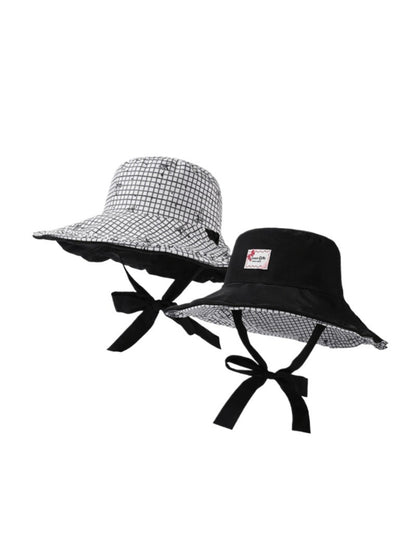 Close-up of Haila bucket hat fabric texture with beige and brown check design