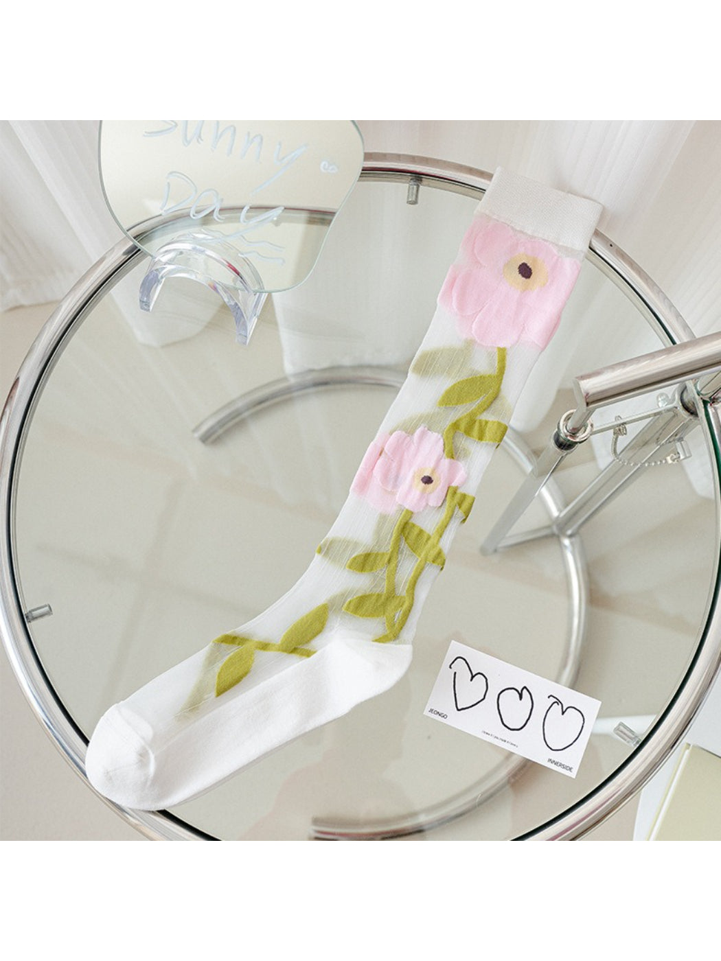 Rufia Bloom mesh knee high socks folded to display floral design and mesh fabric
