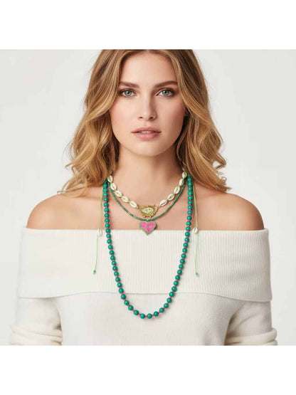 Neckit layered beaded necklace with leaf pendant shown against a light gray background