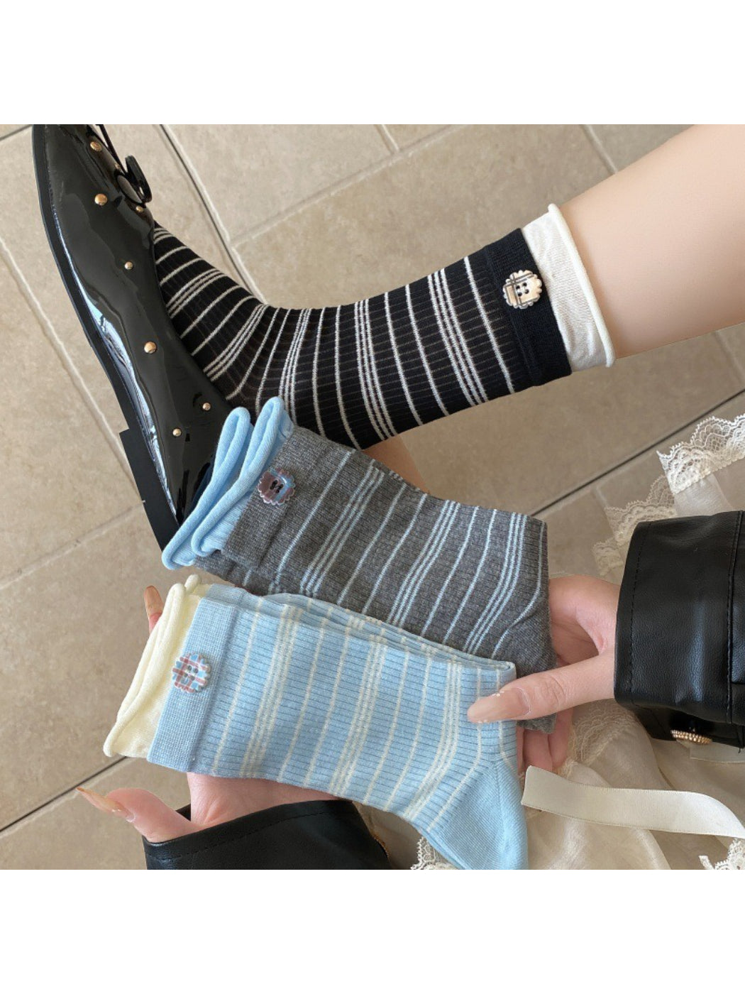 Close-up of Rufia ribbed socks with button detail in beige color